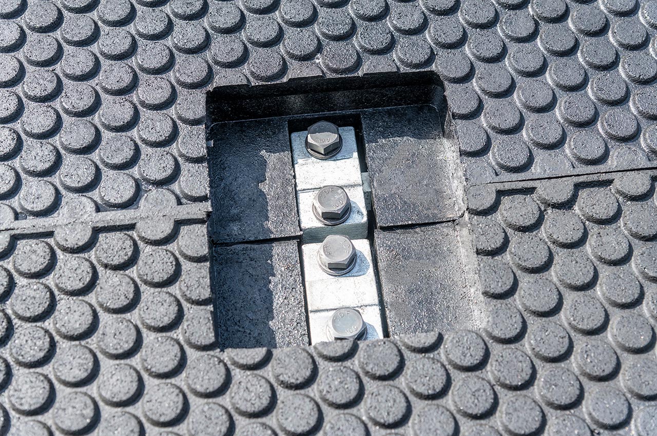 Close-up of bolt fixings flush with panel surface