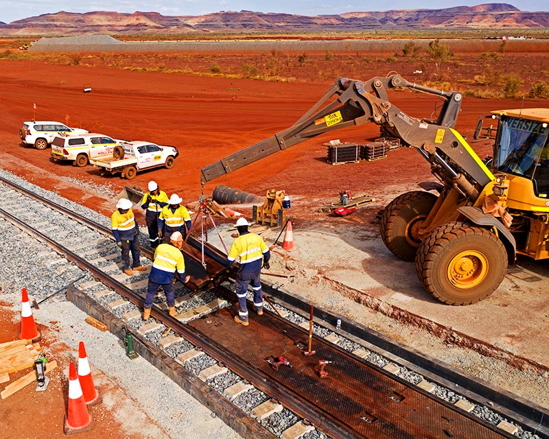 Crew installing TITAN panels at a mining rail crossing in the Australian outback
