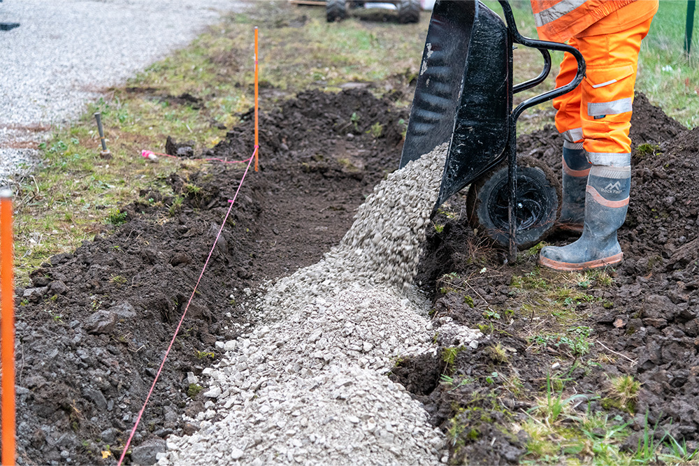 Compacting gravel sub-base with plate compactor