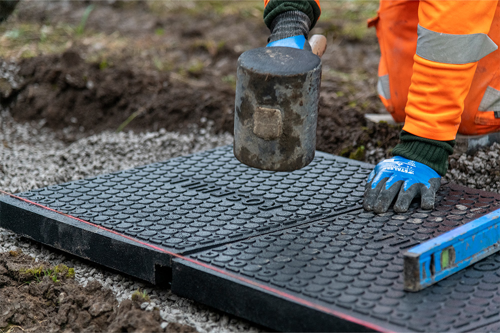 Levelling walkway panel with mallet and spirit level